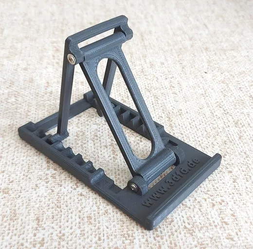 Adjustable folding 3D printed phone stand holding a smartphone upright